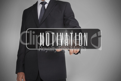 Businessman selecting the word motivation written on black tag