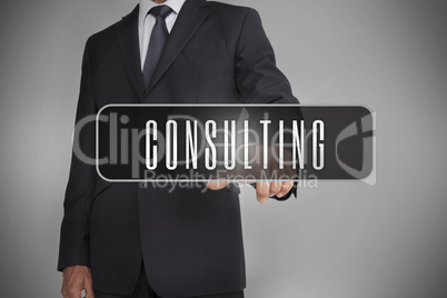 Businessman selecting the word consulting written on black tag