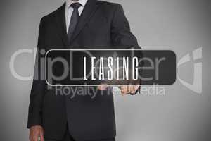 Businessman selecting label with leasing written on it