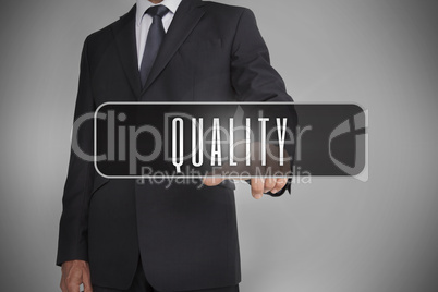Businessman selecting label with quality written on it
