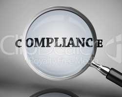 Magnifying glass showing compliance word