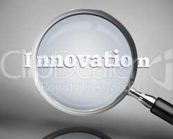 Magnifying glass showing innovation word in white
