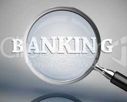 Magnifying glass showing banking word in white