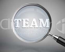 Magnifying glass showing team word in white