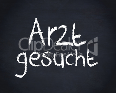 German word arzt gesucht written on a blackboard