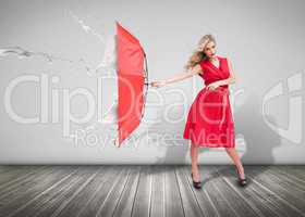 Attractive woman holding an umbrella to protect herself from the