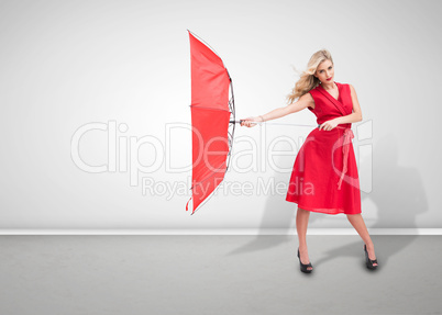 Beautiful woman wearing red dress and holding umbrella