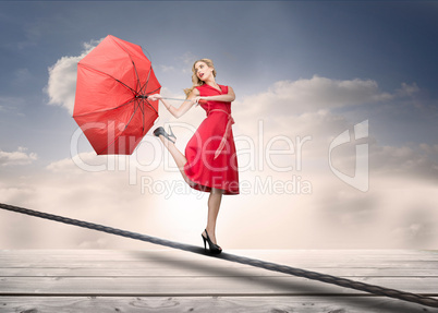 Pretty woman with a broken umbrella over the clouds