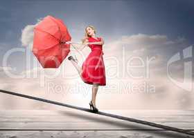 Pretty woman with a broken umbrella over the clouds