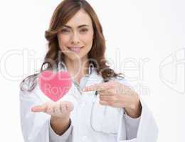 Doctor holding and pointing at a pink heart