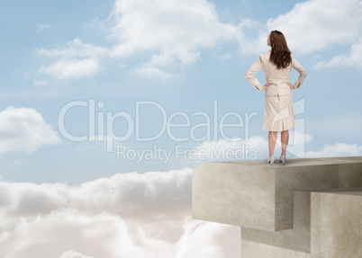 Businesswoman looking at the horizon over the clouds