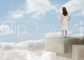 Businesswoman looking at the horizon over the clouds