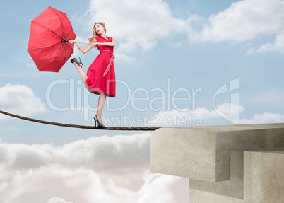 Pretty woman walking on a rope over the clouds