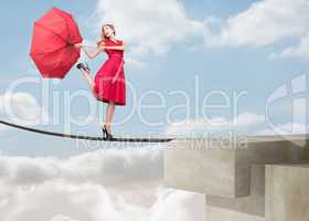 Pretty woman walking on a rope over the clouds