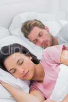 Peaceful couple sleeping in bed