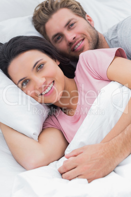 Portrait of a couple embracing in bed