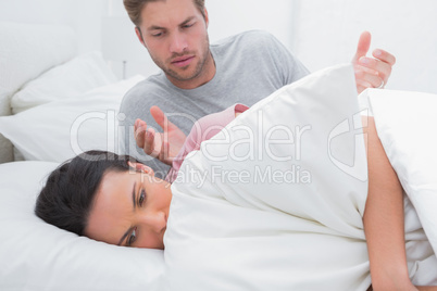 Angry woman sulking in bed during a conflict