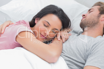 Woman sleeping on her husbands chest