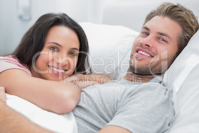 Happy couple awaking and looking at camera