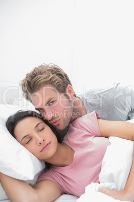 Man kissing his sleeping wife