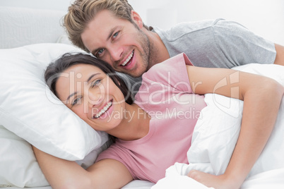 Couple laughing and looking at camera