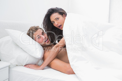 Couple surprised in bed