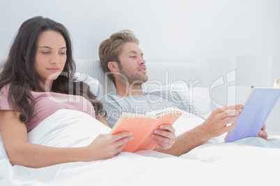 Couple reading in their bed