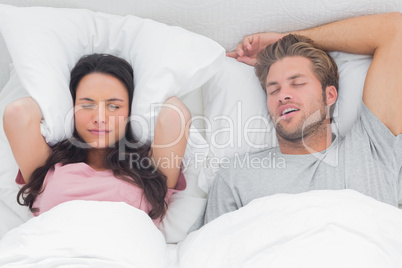 Woman annoyed by the snoring of her partner