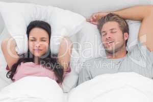 Woman annoyed by the snoring of her partner