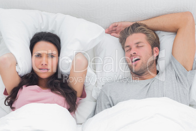 Woman annoyed by the snoring of her husband