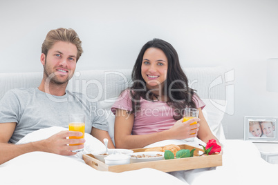 Couple having breakfast in bed