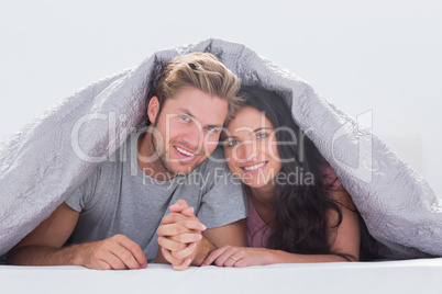 Beautiful couple under the quilt