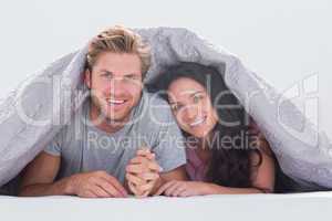 Cheerful couple under the cover