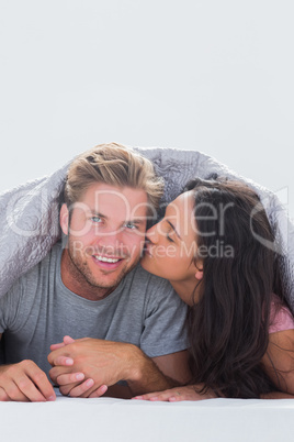 Woman kissing her husband while they are hand in hand