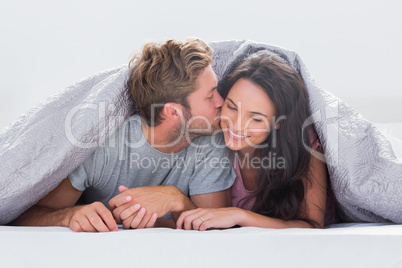 Attractive man kissing his wife