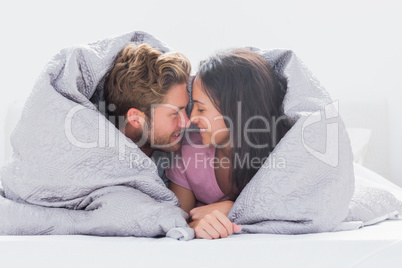 Couple wrapped in the duvet