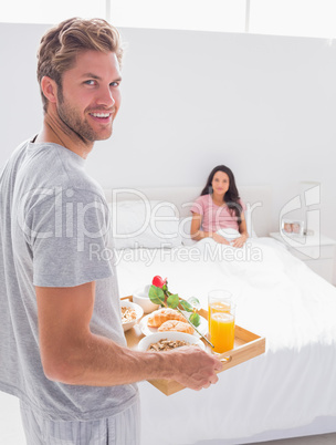 Man bringing breakfast to his wife