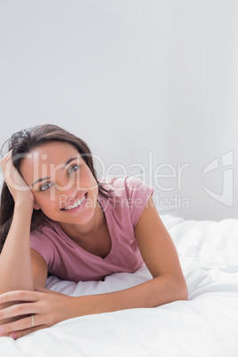 Cheerful woman holding her head