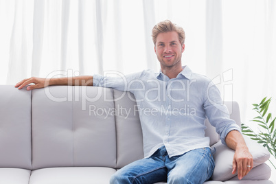 Man sat on a couch in the living room