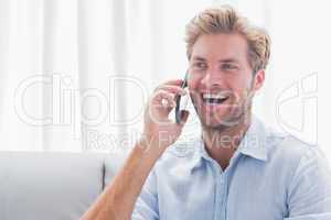 Man laughing while he is on the phone