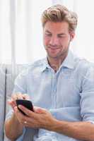 Man using his smartphone on a couch