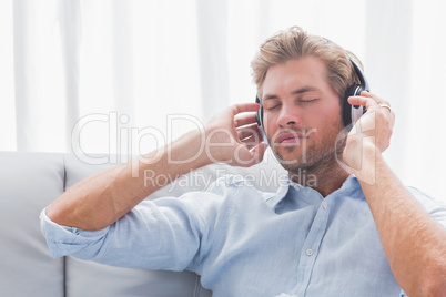 Man listening to music on a couch