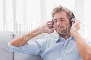Man listening to music on a couch