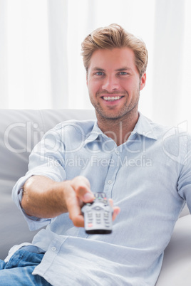 Man pointing remote control at the camera