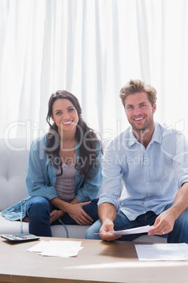 Couple smiling while doing their accounts