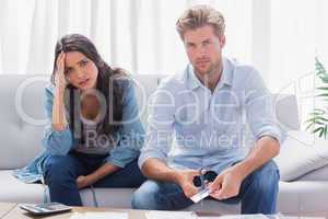Couple looking anxious while doing their accounts