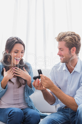 Handsome man offering an engagement ring