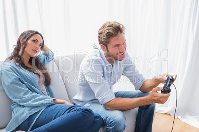 Woman annoyed that her partner is playing video games
