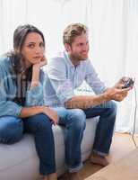 Sad woman annoyed that her partner is playing video games