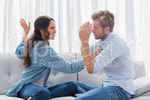 Upset woman about to slap her partner